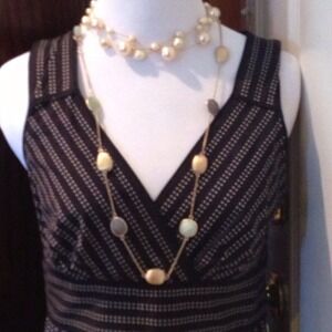 Long gold colored necklace with blue/green stones